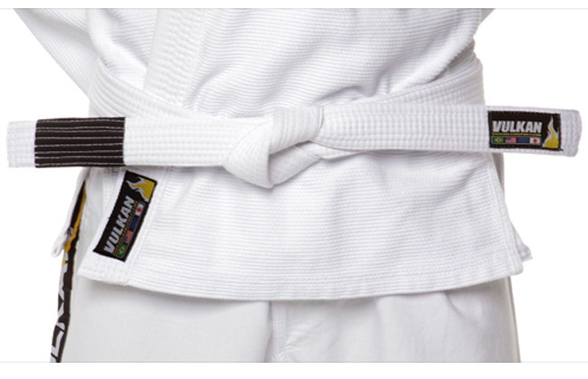 white jiu-jitsu belt tied around a white martial arts uniform